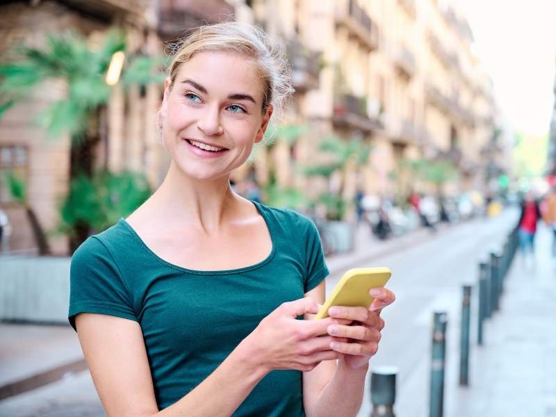 woman looking up fertility clinic SART success rates on her phone