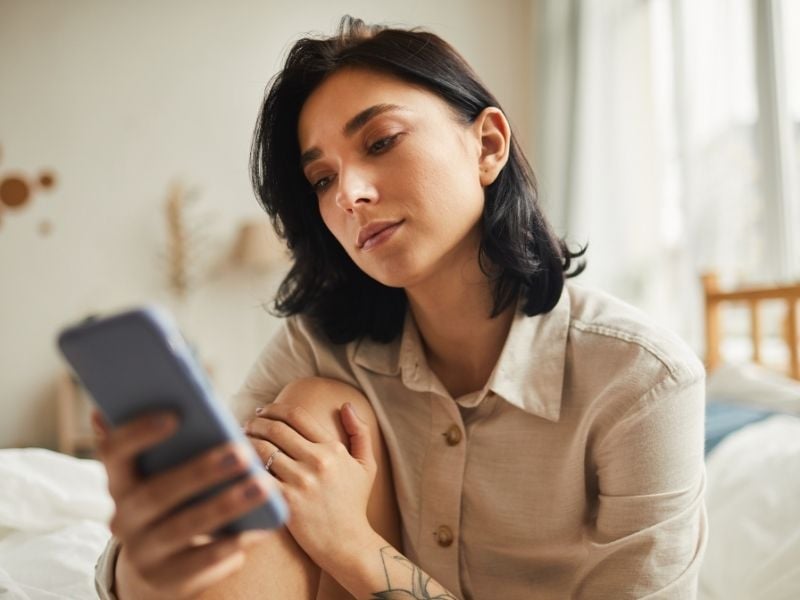 woman using fertility apps on her phone