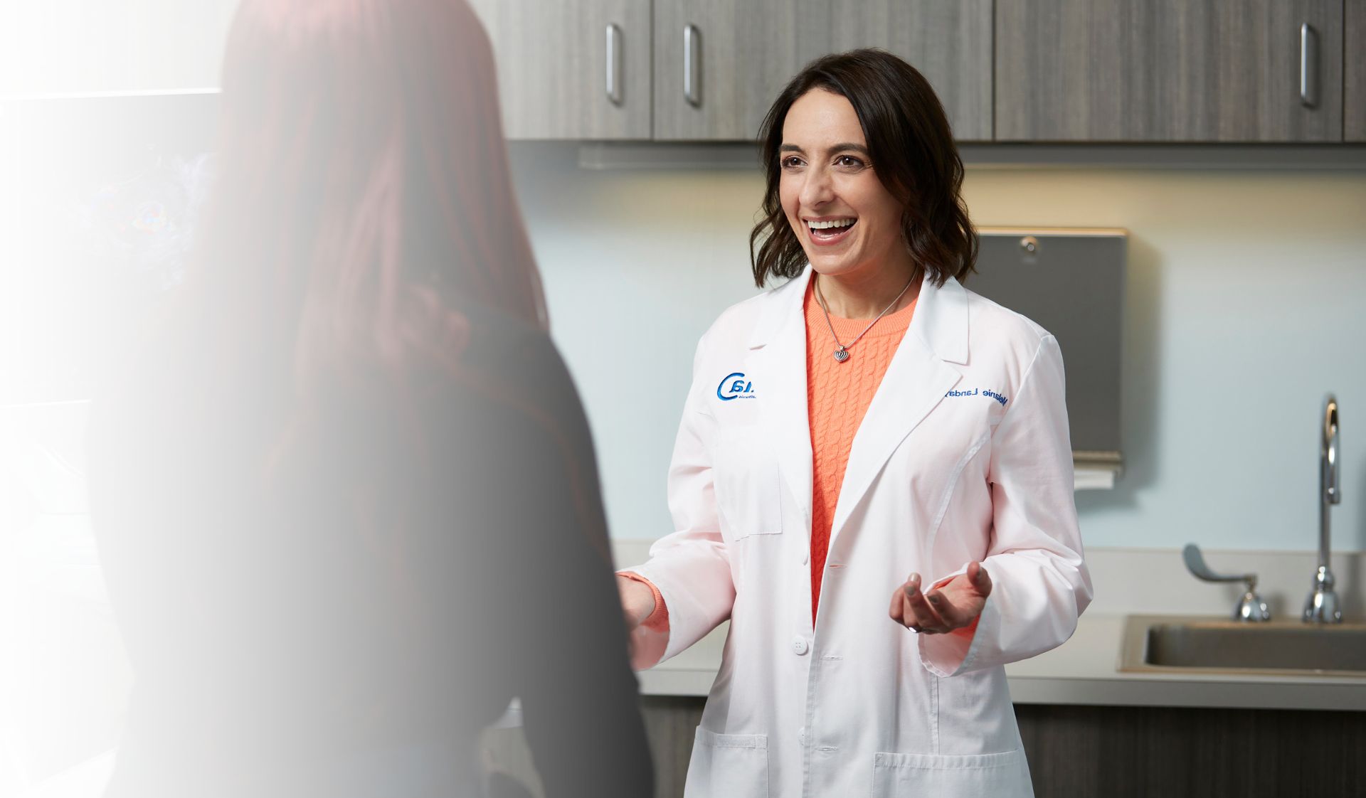 dr. melanie landay discussing single embryo transfer with patient