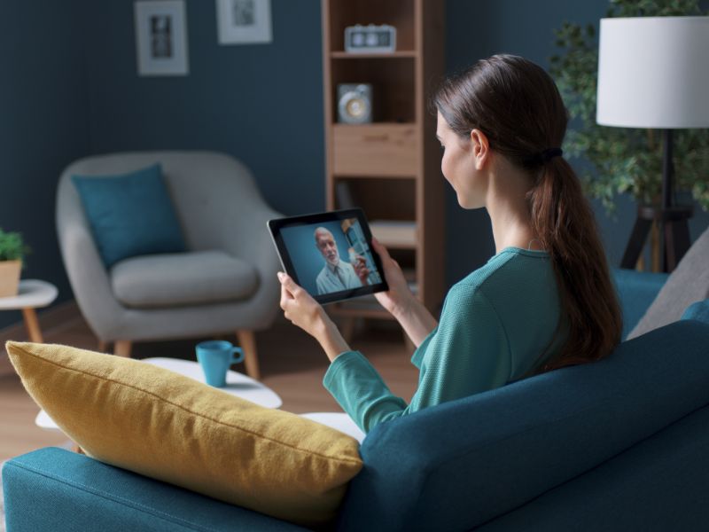 Woman video chatting on tablet doing telehealth fertility care
