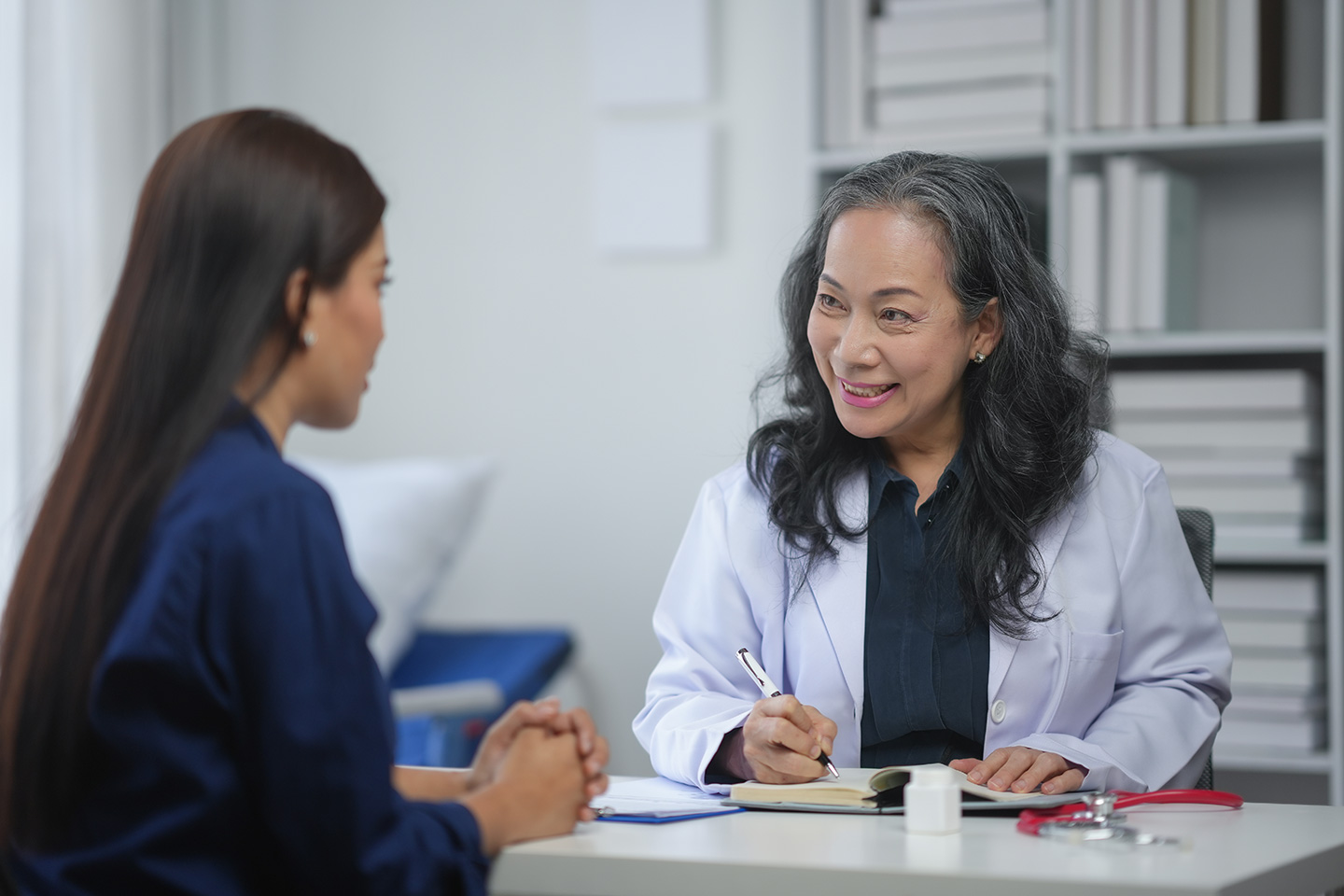 A woman speaks to a doctor while looking for the best fertility clinic in Philadelphia